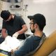 Jeffrey Tibbetts removing a magnet implant from Zac Shannon’s finger.